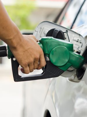 Refueling Car With Gasoline Pump Nozzle, Selective Focus on pump nozzle